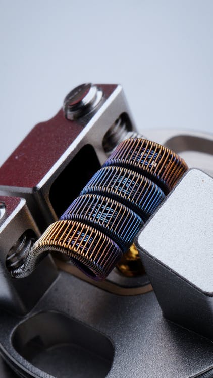 Free Closeup of fused clapton coil on dripper of modern electronic cigarette on white background Stock Photo
